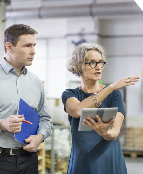 Manager discussing with male worker at printing plant